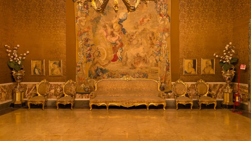 Ornate room with antique furniture and large tapestry
